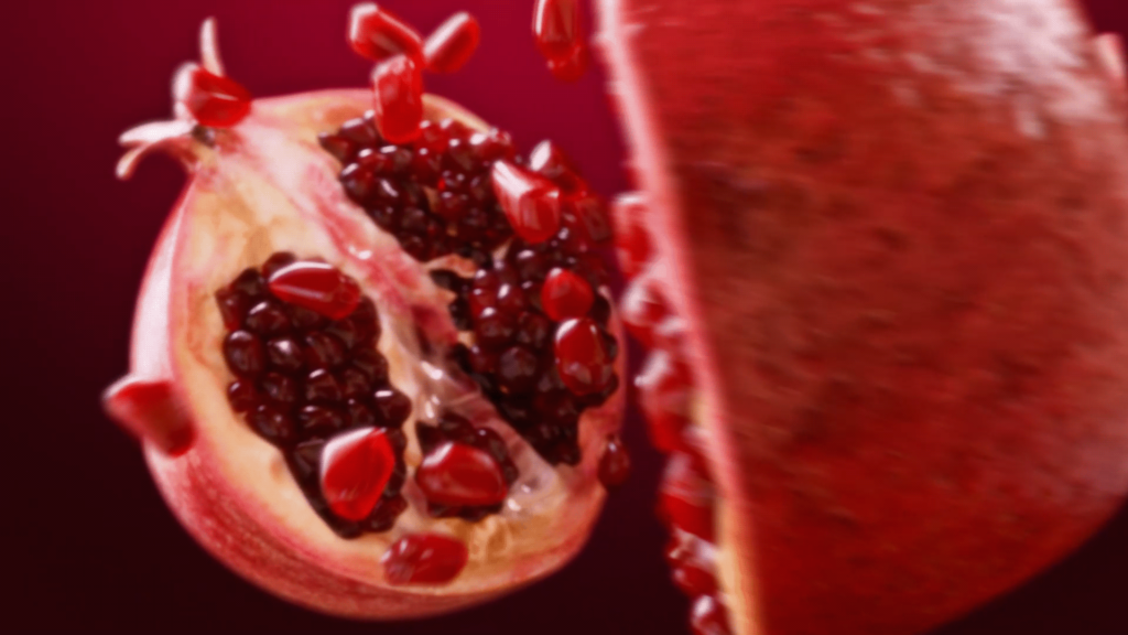 Pomegranate split open, seeds visible.